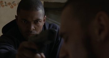 Movie still from “Adulthood” (2008), directed by Noel Clarke – A person with a knife in his hand; Close Up shot, Over the shoulder angle