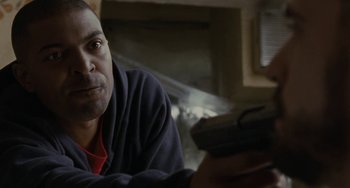 Movie still from “Adulthood” (2008), directed by Noel Clarke – A person sitting in front of a window; Close Up shot, Low angle