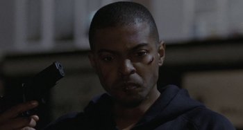 Movie still from “Adulthood” (2008), directed by Noel Clarke – A person with a gun in his hand; Close Up shot, Low angle