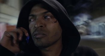 Movie still from “Adulthood” (2008), directed by Noel Clarke – A person wearing a hooded sweatshirt; Close Up shot, Low angle