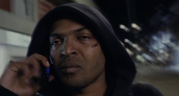 Movie still from “Adulthood” (2008), directed by Noel Clarke – A person talking on a cell phone; Close Up shot, Low angle
