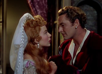 Movie still from “Adventures of Don Juan” (1948), directed by Vincent Sherman – A man and a woman are looking at one another; Close Up shot, Over the shoulder angle