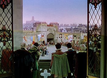 Movie still from “Adventures of Don Juan” (1948), directed by Vincent Sherman – A group of people standing on top of a building; Extreme Wide shot, High angle
