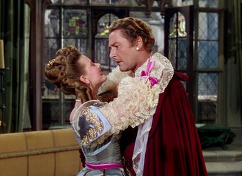 Movie still from “Adventures of Don Juan” (1948), directed by Vincent Sherman – A man and a woman dressed in medieval garb; Medium shot, Over the shoulder angle