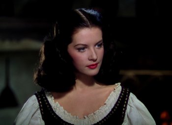 Movie still from “Adventures of Don Juan” (1948), directed by Vincent Sherman – A beautiful woman with long black hair wearing a black and white dress; Close Up shot, High angle