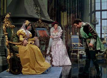 Movie still from “Adventures of Don Juan” (1948), directed by Vincent Sherman – A group of people standing around in a room; Wide shot, Over the shoulder angle