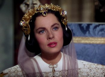 Movie still from “Adventures of Don Juan” (1948), directed by Vincent Sherman – A woman wearing a tiara and a white dress; Close Up shot, Over the shoulder angle