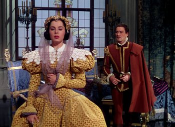Movie still from “Adventures of Don Juan” (1948), directed by Vincent Sherman – A man and a woman dressed in medieval costumes; Medium shot, Over the shoulder angle
