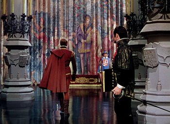 Movie still from “Adventures of Don Juan” (1948), directed by Vincent Sherman – Two men in medieval garb in front of a painting; Wide shot, Over the shoulder angle
