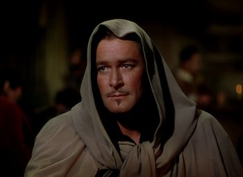 Movie still from “Adventures of Don Juan” (1948), directed by Vincent Sherman – A person wearing a robe and a hood; Close Up shot, Over the shoulder angle