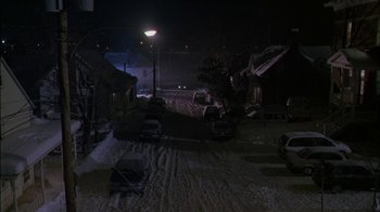 Movie still from “Affliction” (1997), directed by Paul Schrader – Cars parked on the side of the road at night; Extreme Wide shot, High angle