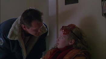 Movie still from “Affliction” (1997), directed by Paul Schrader – A man and a girl are talking to each other; Close Up shot, Over the shoulder angle