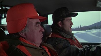 Movie still from “Affliction” (1997), directed by Paul Schrader – Two men are sitting in the drivers seat of a car; Close Up shot, Over the shoulder angle