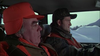 Movie still from “Affliction” (1997), directed by Paul Schrader – Two men in orange jackets in a vehicle; Close Up shot, Over the shoulder angle