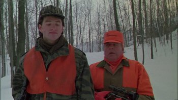 Movie still from “Affliction” (1997), directed by Paul Schrader – A man and a young boy in orange jackets; Medium shot, Over the shoulder angle