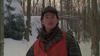 Movie still from “Affliction” (1997), directed by Paul Schrader – A young man in a camouflage vest in the snow; Close Up shot, Low angle