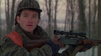 Movie still from “Affliction” (1997), directed by Paul Schrader – A man with a rifle in the snow; Close Up shot, Over the shoulder angle