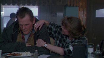 Movie still from “Affliction” (1997), directed by Paul Schrader – A man and a woman sitting at a dinner table; Medium shot, Over the shoulder angle