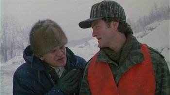 Movie still from “Affliction” (1997), directed by Paul Schrader – Two men talking to each other in the snow; Medium shot, Over the shoulder angle