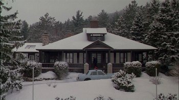 Movie still from “Affliction” (1997), directed by Paul Schrader – A car parked in front of a house on a snowy day; Extreme Wide shot, Low angle
