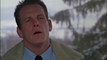 Movie still from “Affliction” (1997), directed by Paul Schrader – A person wearing a suit and tie; Close Up shot, Low angle
