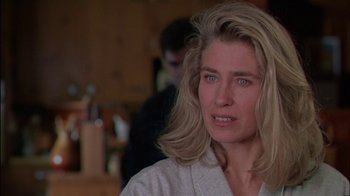 Movie still from “Affliction” (1997), directed by Paul Schrader – A person with long blonde hair; Close Up shot, Over the shoulder angle