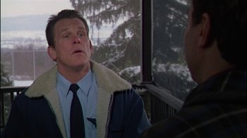 Movie still from “Affliction” (1997), directed by Paul Schrader – A man wearing a jacket and tie talking to another man; Close Up shot, Over the shoulder angle