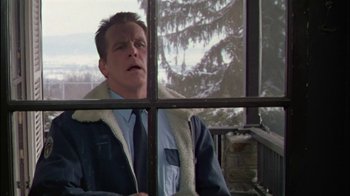 Movie still from “Affliction” (1997), directed by Paul Schrader – A man looking out of a window at a snowy tree; Medium shot, Low angle