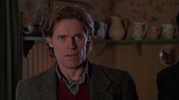 Movie still from “Affliction” (1997), directed by Paul Schrader – A person wearing a suit and tie; Close Up shot, Low angle