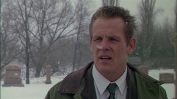 Movie still from “Affliction” (1997), directed by Paul Schrader – A person wearing a jacket and tie; Close Up shot, Low angle