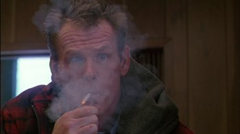 Movie still from “Affliction” (1997), directed by Paul Schrader – A person holding a cigarette in his mouth; Close Up shot, Low angle