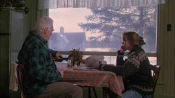 Movie still from “Affliction” (1997), directed by Paul Schrader – A man and a woman sitting at a table; Medium shot, Over the shoulder angle