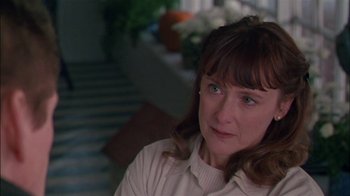 Movie still from “Affliction” (1997), directed by Paul Schrader – A person sitting on a chair; Close Up shot, Over the shoulder angle