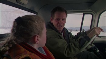 Movie still from “Affliction” (1997), directed by Paul Schrader – A man and a child in a car; Close Up shot, Over the shoulder angle
