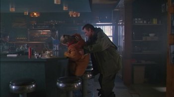 Movie still from “Affliction” (1997), directed by Paul Schrader – A man and a stuffed animal in a bar; Wide shot, Over the shoulder angle