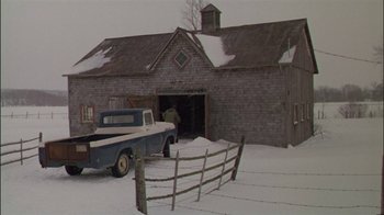 Movie still from “Affliction” (1997), directed by Paul Schrader – An old truck parked in front of an old barn; Wide shot, High angle