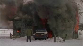 Movie still from “Affliction” (1997), directed by Paul Schrader – A man standing in front of a truck in the snow; Extreme Wide shot, Over the shoulder angle