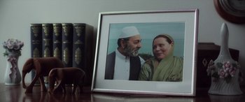 Movie still from “After Love” (2020), directed by Aleem Khan – A picture of an older man and a younger woman in a picture frame; Extreme Close Up shot, Over the shoulder angle