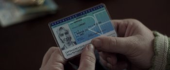 Movie still from “After Love” (2020), directed by Aleem Khan – A person holding a french driver's license in their hand; Extreme Close Up shot, High angle