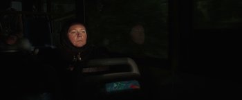 Movie still from “After Love” (2020), directed by Aleem Khan – A woman sitting on a bus in the dark; Close Up shot, Low angle