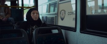 Movie still from “After Love” (2020), directed by Aleem Khan – A woman sitting on a bus looking out of the window; Close Up shot, Low angle