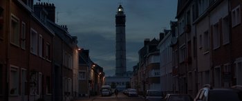 Movie still from “After Love” (2020), directed by Aleem Khan – A tall light tower towering over a city street at night; Extreme Wide shot, Low angle