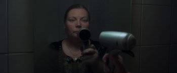 Movie still from “After Love” (2020), directed by Aleem Khan – A woman in the mirror holding a hair dryer; Close Up shot, Over the shoulder angle