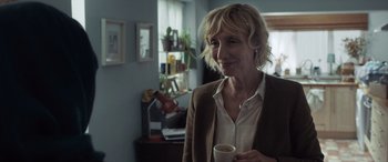 Movie still from “After Love” (2020), directed by Aleem Khan – A woman holding a coffee cup in a room; Close Up shot, Over the shoulder angle