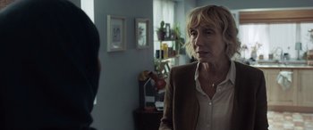 Movie still from “After Love” (2020), directed by Aleem Khan – A woman is talking to a man in a room; Close Up shot, Over the shoulder angle