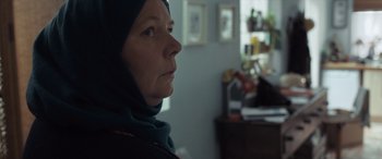Movie still from “After Love” (2020), directed by Aleem Khan – A woman wearing a headscarf looking into the distance; Close Up shot, Over the shoulder angle
