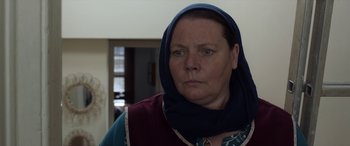 Movie still from “After Love” (2020), directed by Aleem Khan – A person wearing a headscarf; Close Up shot, Over the shoulder angle