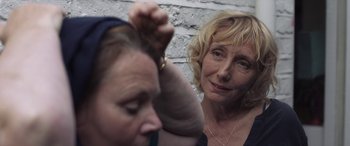 Movie still from “After Love” (2020), directed by Aleem Khan – An older woman is combing a younger woman's hair; Close Up shot, Over the shoulder angle