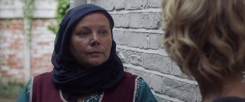Movie still from “After Love” (2020), directed by Aleem Khan – A woman wearing a headscarf is looking into the camera; Close Up shot, Over the shoulder angle