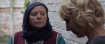 Movie still from “After Love” (2020), directed by Aleem Khan – A woman wearing a headscarf is looking at another woman; Close Up shot, Over the shoulder angle